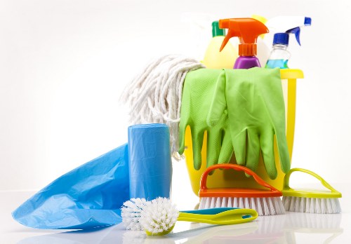 Cleaner handling carpet cleaning product safely with gloves