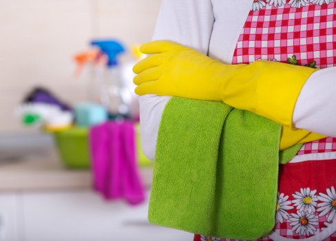 Cleaner managing hoses and preventing slip hazards during service